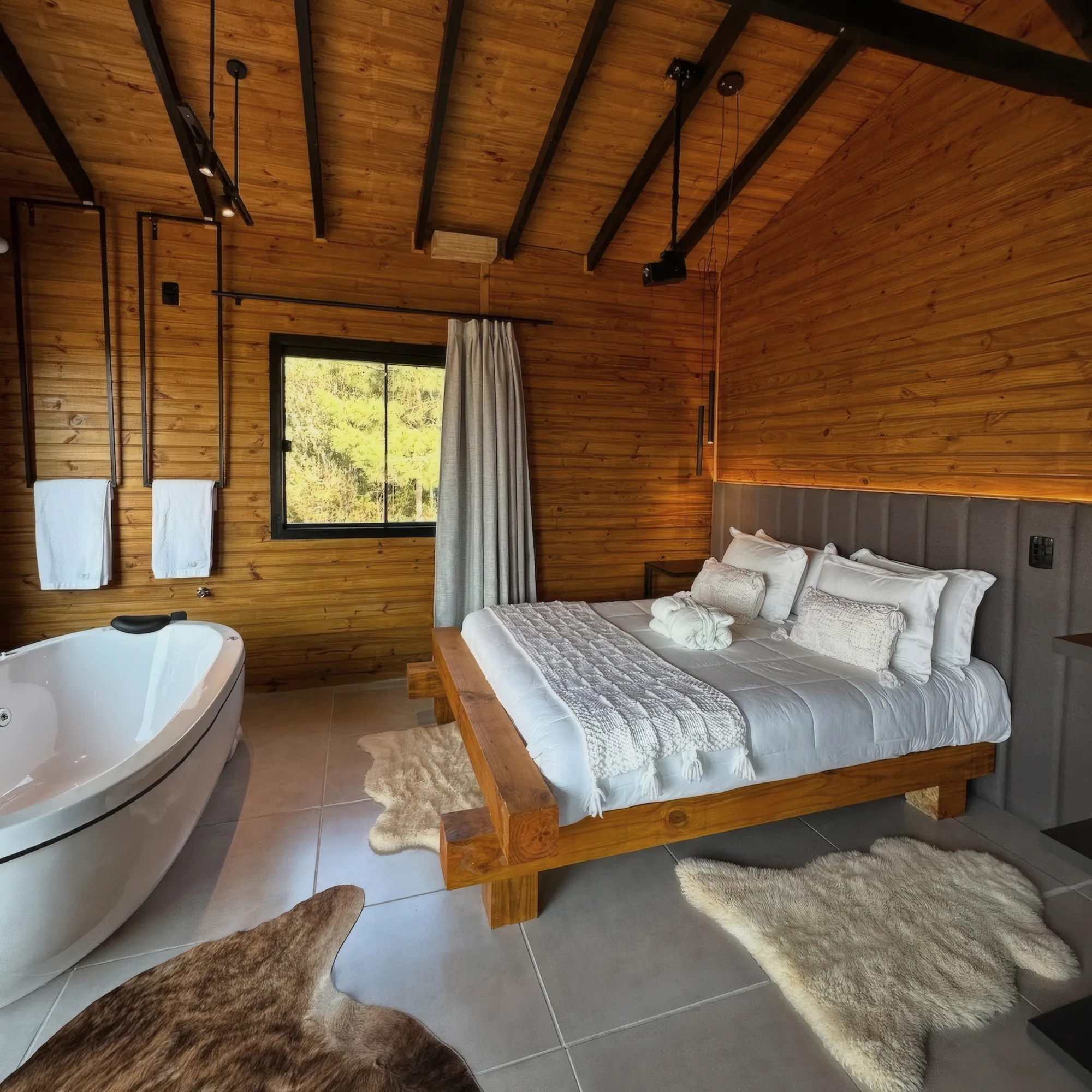 Quarto em madeira com cama queen e banheira de imersão